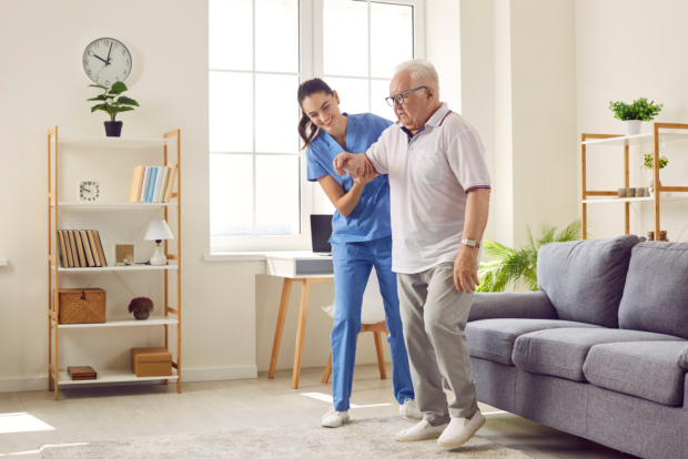 carer assisting senior man